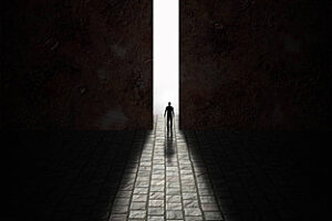 A door cracked open to reveal glowing light