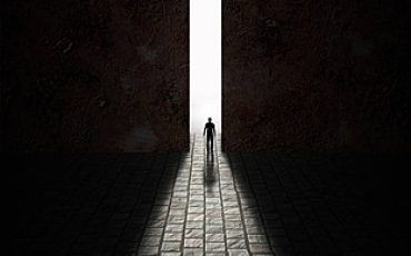 A door cracked open to reveal glowing light